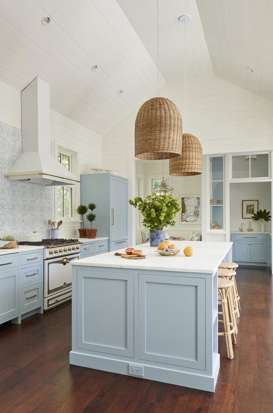 https://www.digsdigs.com/photos/2023/01/a-beautiful-coastal-kitchen-in-light-blue-and-white-with-a-mosaic-tile-backsplash-wicker-lampshades-and-rattan-stools-plus-greenery.jpg