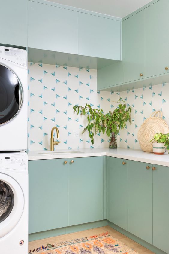 https://www.digsdigs.com/photos/2023/02/46-a-mint-green-laundry-room-with-a-catchy-backsplash-gold-fixtures-and-stacked-appliances-is-a-cool-space.jpg