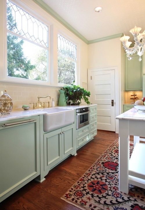 https://www.digsdigs.com/photos/2023/03/a-mint-farmhouse-kitchen-with-shaker-cabinets-white-stone-countertops-a-bold-printed-rug-and-a-vintage-chandelier.jpg