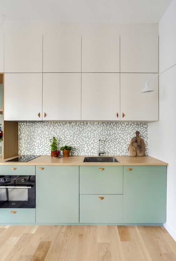 https://www.digsdigs.com/photos/2023/03/a-two-tone-kitchen-with-creamy-and-mint-cabinets-butcherblock-cabinets-a-mosaic-backsplash-and-butcherblock-counterts.jpg
