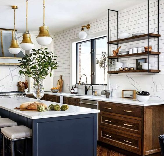https://www.digsdigs.com/photos/2023/05/04-a-chic-modern-kitchen-with-stained-cabinets-a-navy-kitchen-island-white-countertops-and-a-backsplash-suspended-shelves-and-brass-pendant-lamps.jpg