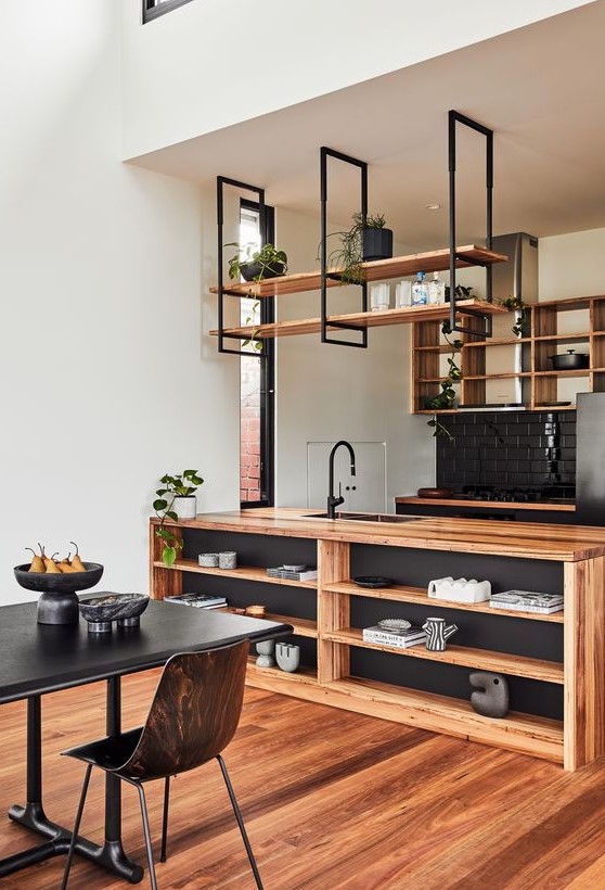 https://www.digsdigs.com/photos/2023/05/17-a-stylish-kitchen-in-black-and-light-stained-wood-with-open-cabinets-and-suspended-shelves-a-storage-kitchen-island-and-potted-greenery.jpg