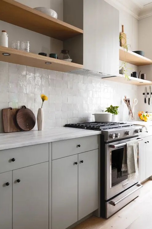 Grey kitchen cabinets against sage green walls in an attic apartment - COCO  LAPINE DESIGNCOCO LAPINE DESIGN