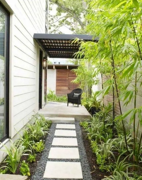 a low-maintenance side yard with pebbles, tiles, greenery and bamboo is a lovely idea for a modern home