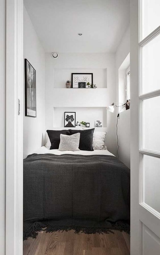 https://www.digsdigs.com/photos/2023/08/30-a-tiny-bedroom-in-white-with-only-a-bed-squuzed-in-black-and-white-bedding-niche-shelves-with-decor-an-artwork-and-a-sconce.jpg