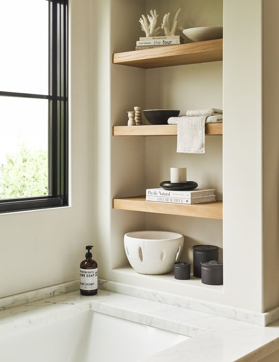 https://www.digsdigs.com/photos/2023/08/33-a-neutral-bathroom-with-a-niche-with-wooden-shelves-used-for-placing-decor-there-to-make-the-bathroom-look-cooler.jpg