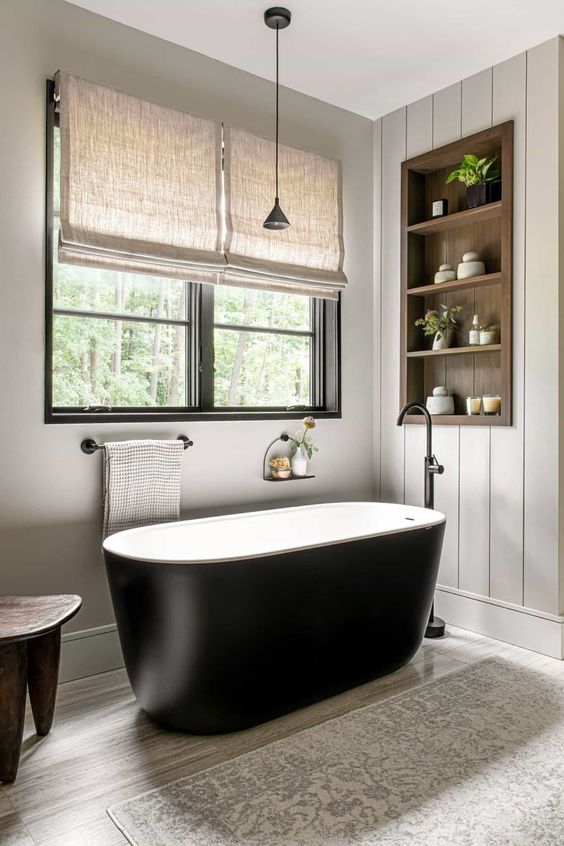 https://www.digsdigs.com/photos/2023/08/37-a-neutral-modern-farmhouse-bathroom-clad-with-shiplap-with-an-oval-black-tub-a-timber-niche-with-shelves-used-for-decor.jpg