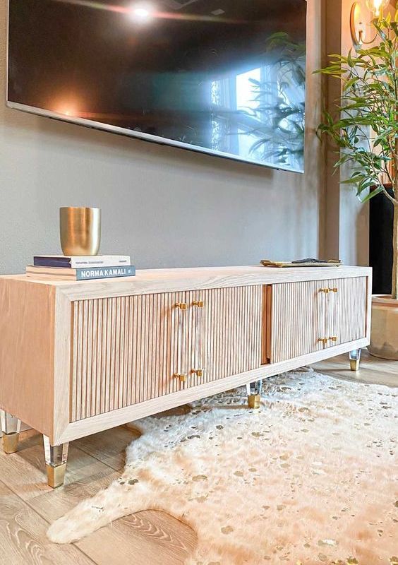 https://www.digsdigs.com/photos/2023/08/40-cool-media-consoles-with-fluted-doors-acrylic-and-gold-legs-and-matching-handles-will-add-special-chic-to-your-living-room.jpg