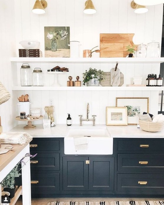 a beautiful black farmhouse kitchen with shaker cabinets, floating shelves, retro sconces and mixed metals for more eye-catchiness