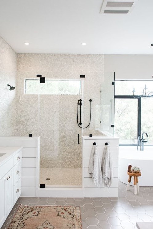 a contemporary farmhouse bathroom with neutral tiles, taupe hex tiles on the floor and a vintage vanity