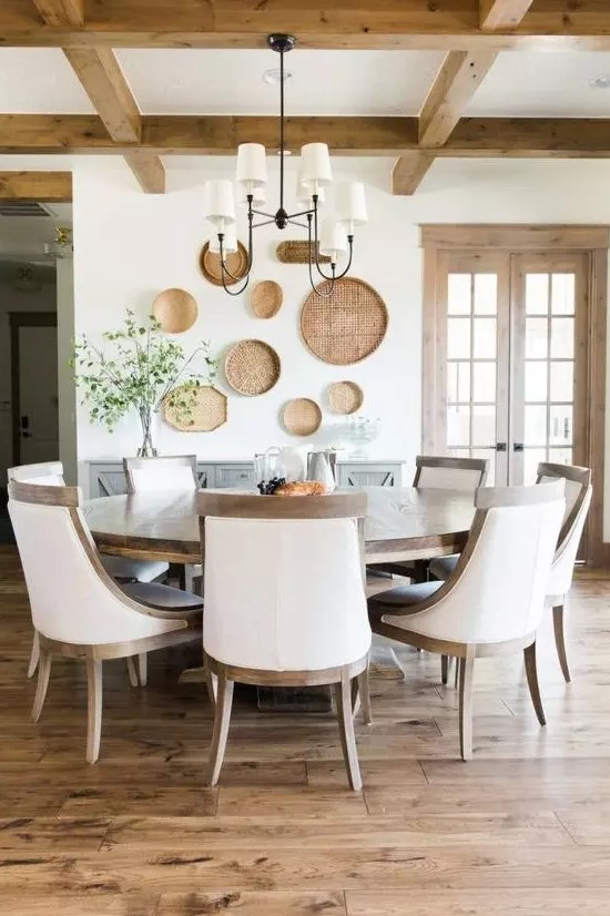 a gorgeous modern farmhouse dining room done in neutrals and with a large wooden round table