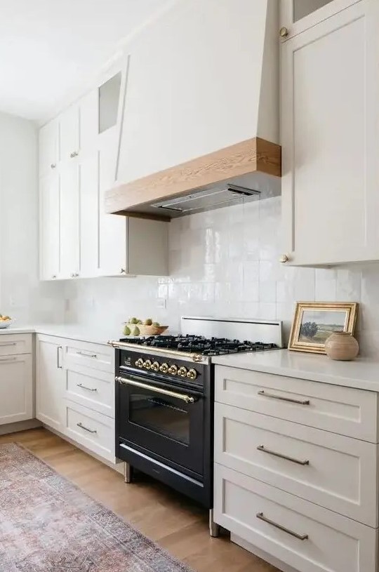 a modern farmhouse kitchen in soft creamy shades, with a white zellige tile backsplash and white stone countertops