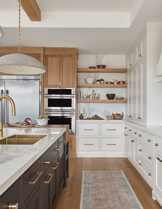 a modern farmhouse kitchen with white cabinets, a black kitchen island, white stone countertops, open shelves and stained storage units