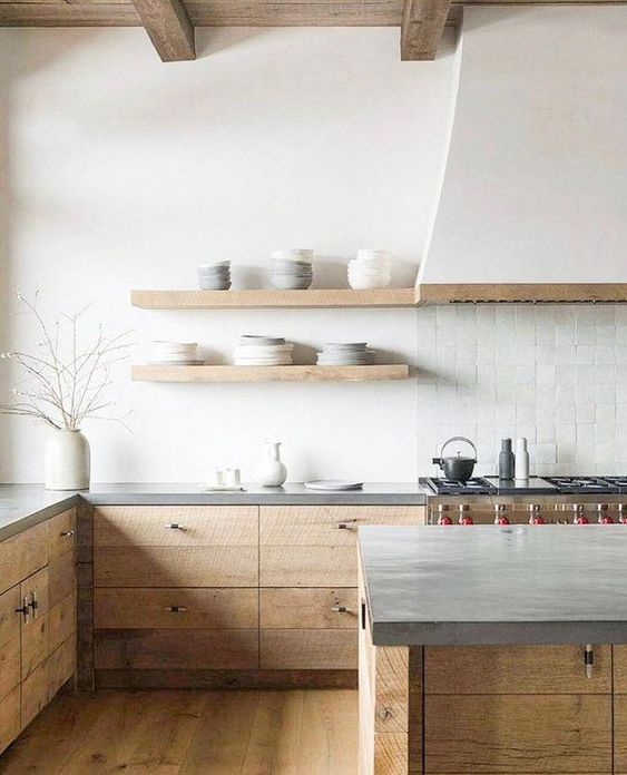 a neutral modern farmhouse kitchen with stained cabinets and a kitchen island, concrete countertops, a white Zellige tile backsplash and open shelves