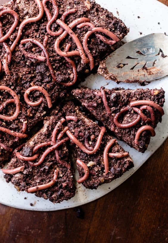 layers of dark chocolate mousse, chocolate pecan cookie dirt and chocolate whipped cream are topped with realistic raspberry gummy worms to make a frightfully delicious Halloween dessert