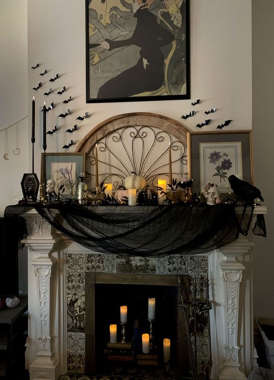 https://www.digsdigs.com/photos/2023/10/a-beautiful-Halloween-fireplace-styled-in-a-classic-way-with-black-cheesecloth-black-candles-white-pumpkins-and-candles-black-bats-on-the-wall.jpg