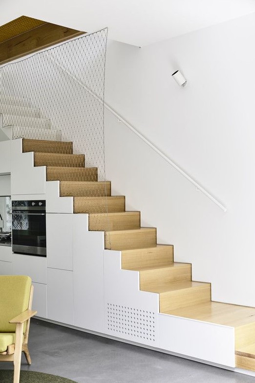 A Minimalist White Kitchen Completely Built Into The Staircase Is A Smart Solution If You Dont Have Space For A Kitchen 