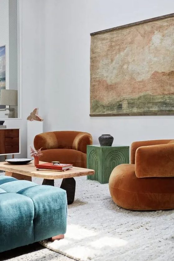 08 A Colorful Living Room With Rust Colored Curved Chairs A Green Coffee Table A Coffee Table A Blue Ottoman An Artwork And A Sideboard 