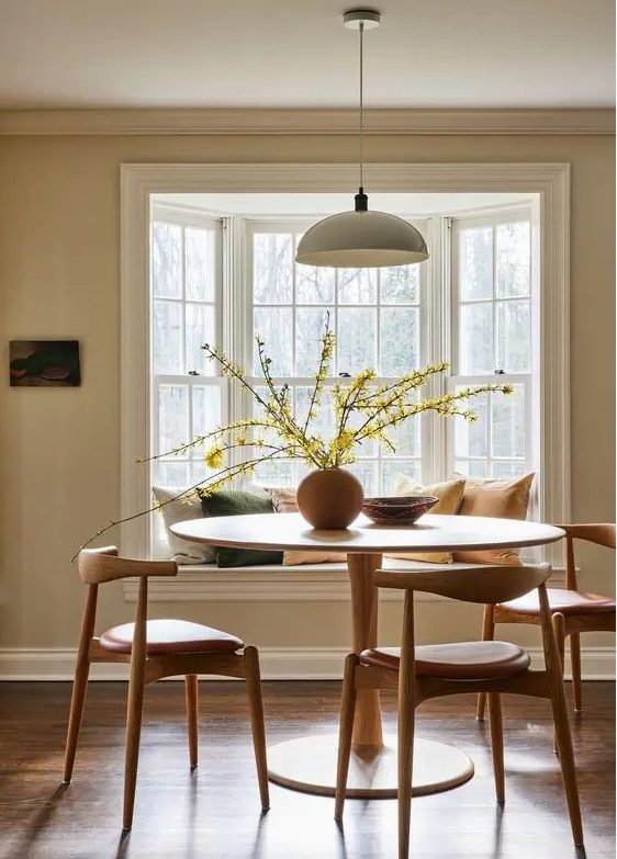 4 Color Trends For 2024 And 47 Ideas DigsDigs   19 An Earthy Dining Room With A Bay Window With A Window Seat A Round Table And Mid Century Modern Chairs A Pendant Lamp 