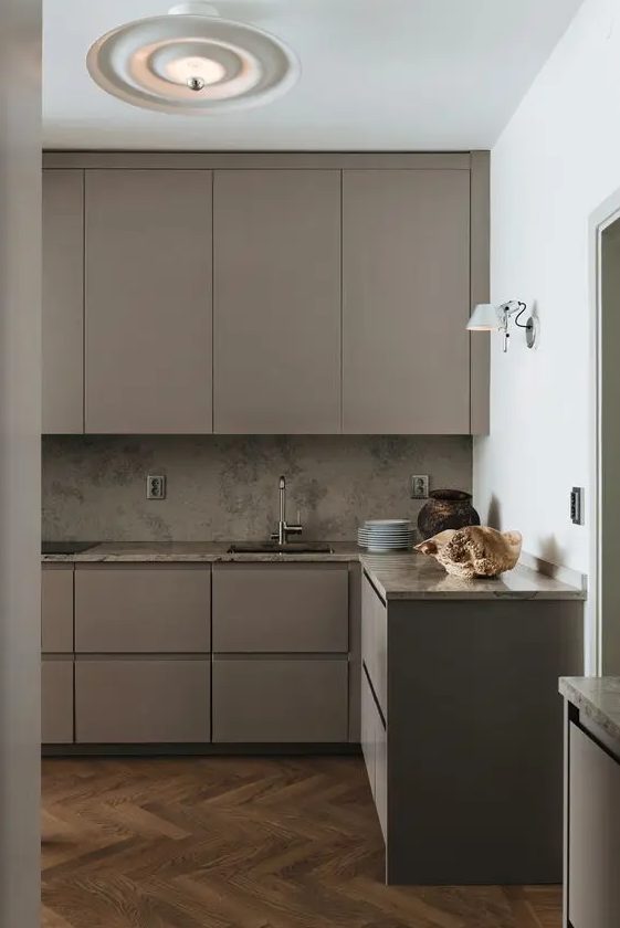 4 Color Trends For 2024 And 47 Ideas DigsDigs   28 A Beautiful Taupe Minimalist Kitchen With Taupe Stone Countertops And A Backsplash Various Lamps And Built In Appliances Is Elegant 