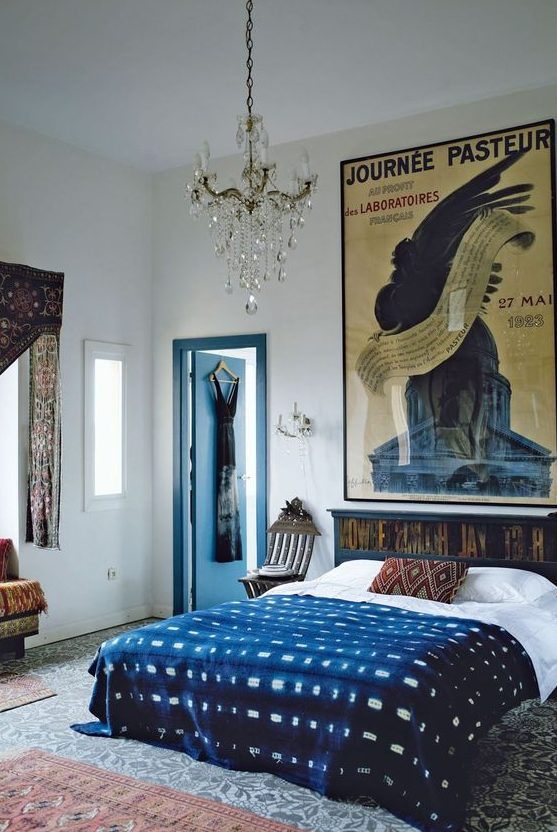 25 An Eclectic Bedroom With A Dark Stained Bed And Printed Bedding Patterned Rugs And Curtains And A Large Poster 