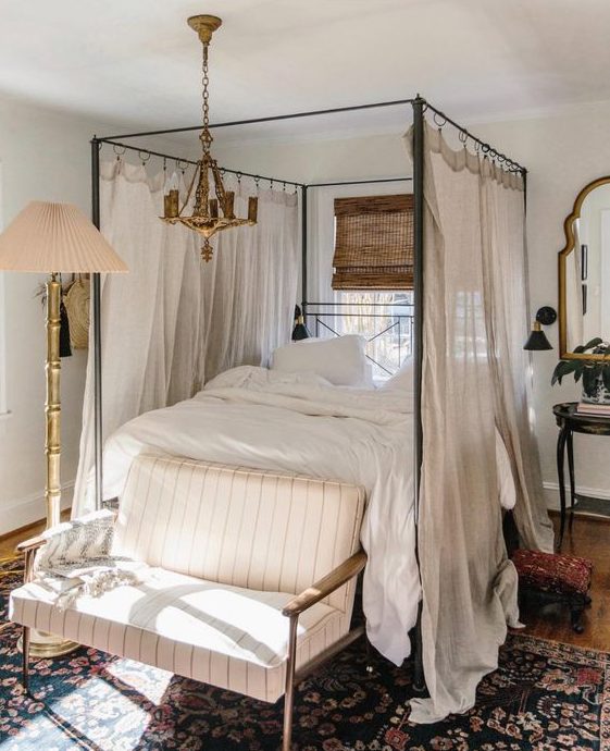 4 Bedroom Trends For 2024 And 40 Examples DigsDigs   33 A Welcoming Vintage Bedroom With A Cnaopy Bed And Neutral Bedding A Striped Loveseat A Floor Lamp And A Gilded Chandelier 