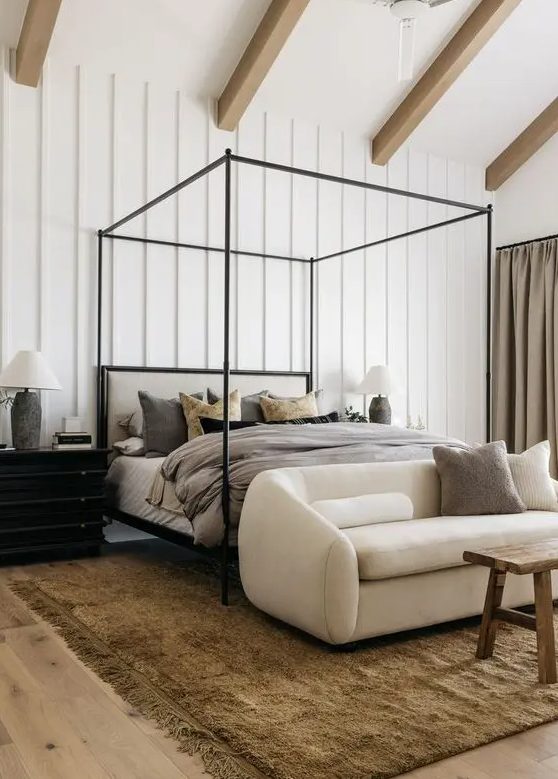 36 A Neutral Eclectic Bedroom With A Frame Bed And Grey Bedding A Creamy Loveseat A Stained Bench A Black Dresser With A Lamp 