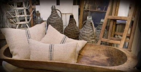 a dough bowl used for storing pillows is a rustic touch to your living room