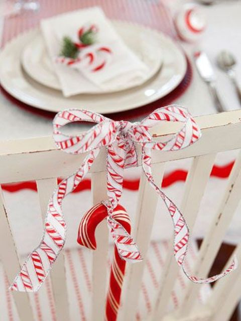 accent your chair with a candy cane and a ribbon bow to make it look cool and bright