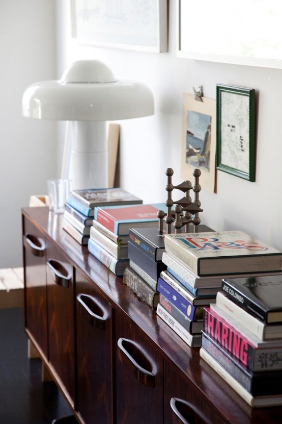 a fab dark-stained sideboard with glossy dark-stained doors and elegant handles is amazing for a mid-century modern space