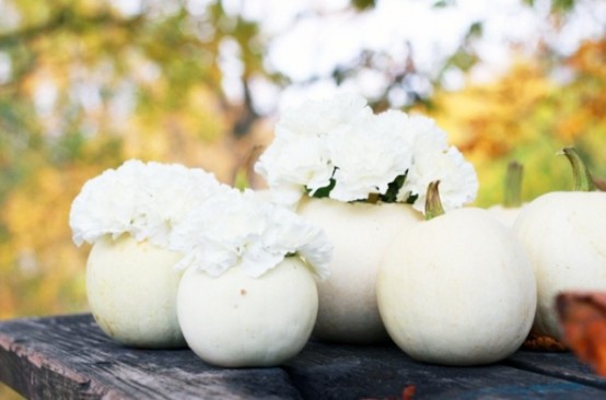 white pumpkins with white blooms can be used for Thanksgiving decor both indoors and outdoors