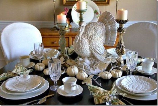 white porcelain, white pumpkins, candles and a large turkey paired with a dark table give a bold and contrasting look to the table